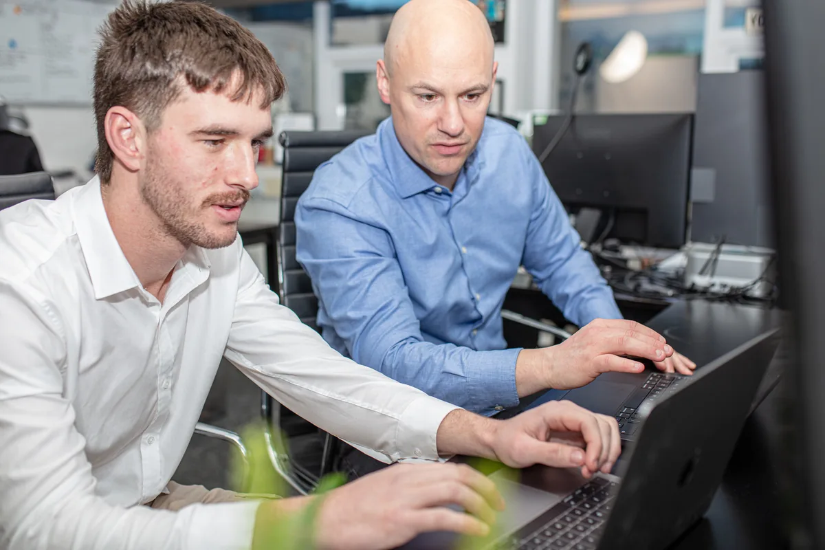 David and Luke from Halizona checking a client&rsquo;s search results together on a laptop